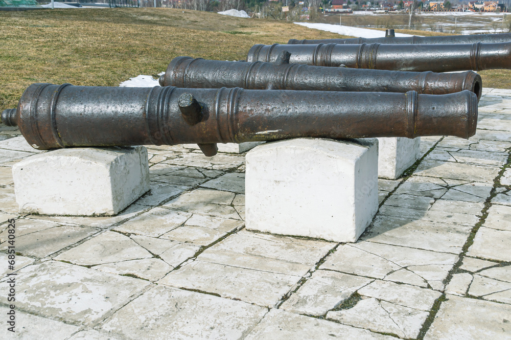 Antique cast iron cannons for firing cores. Ancient weapons for war and defense against attacks.