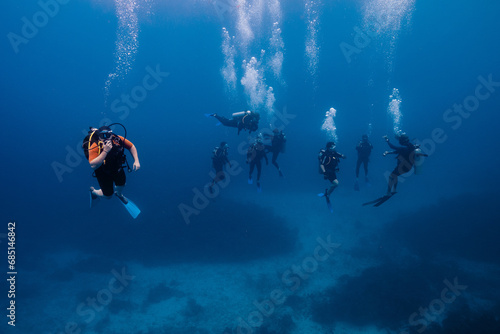 Group of Divers Exploring the Deep Blue Sea in Cancun, Mexico photo