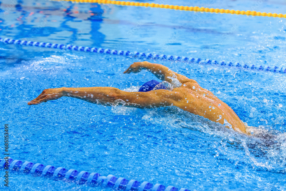 male swimmer swim butterfly in competition race, summer sports games