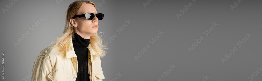 stylish androgynous person in winter jacket with sunglasses looking away, fashion concept, banner stylish androgynous person in winter jacket with sunglasses looking away, fashion concept, banner