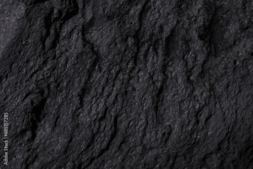 Black stone texture, dark abstract background. Natural mineral rock close up details, empty backdrop with copy space for design