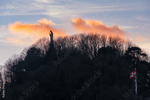 Statue of Jesus at the top of Mount Urgul in San Sebastian, Spain, in the sunset. photo