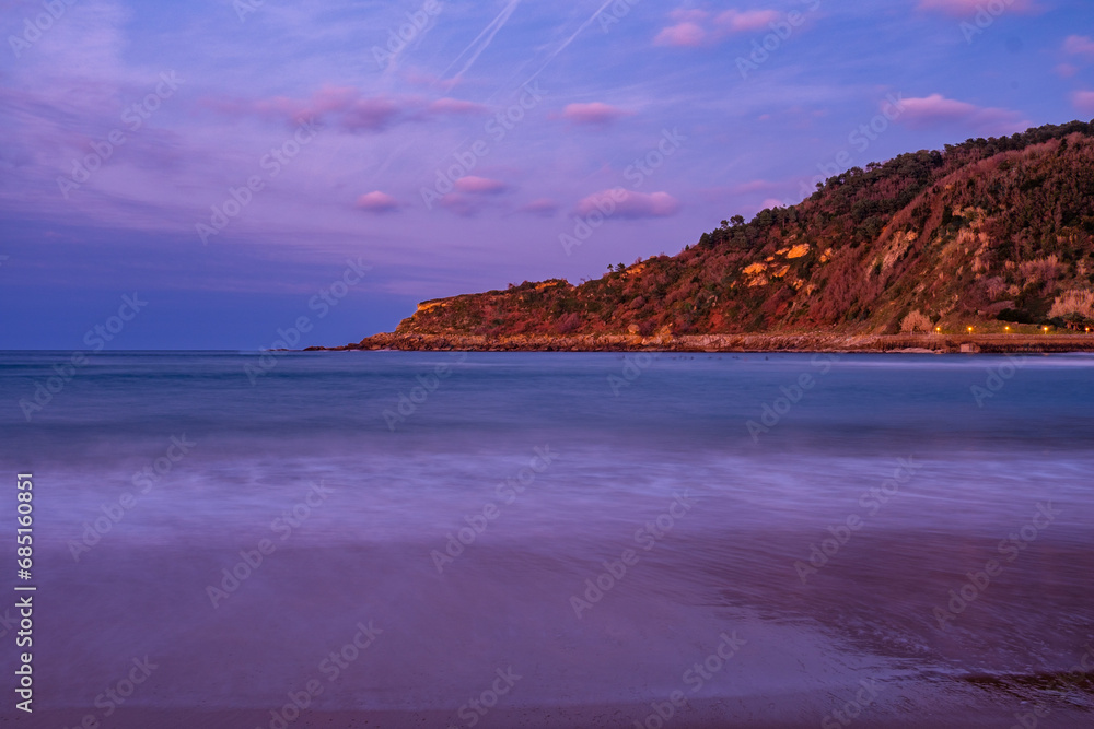 Obraz premium The Zurriola beach of San Sebastian, Spain at Sunset