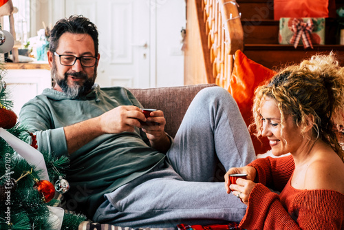 Real life leisure activity in chrismtas holiday at home for man and woman having breakfast together with italian coffee. Happiness and holiday celebration concept lifestyle. Couple in love indoor photo