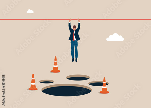 Businessman hangs on for dear life from a rope as he swings above a pits and obstacle. Avoid pitfall. Flat vector illustration