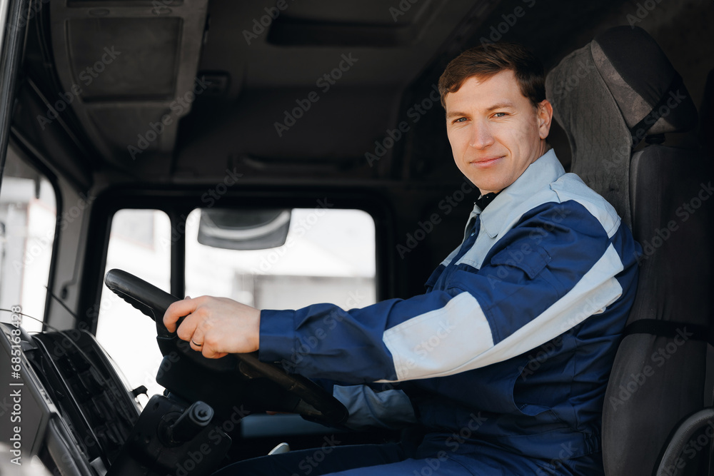 Young man professional driver of mining industrial truck driving Young man professional driver of mining industrial truck driving