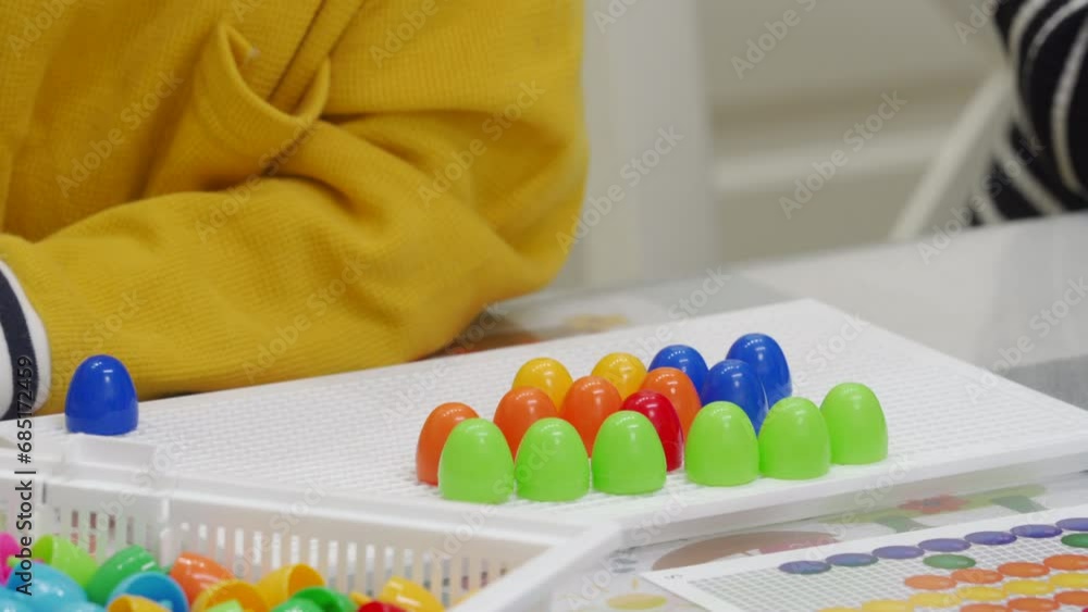 mother and child playing together pegboard mosaic. Early child development. Fine motor skills. Learning and creativity mother and child playing together pegboard mosaic. Early child development. Fine motor skills. Learning and creativity