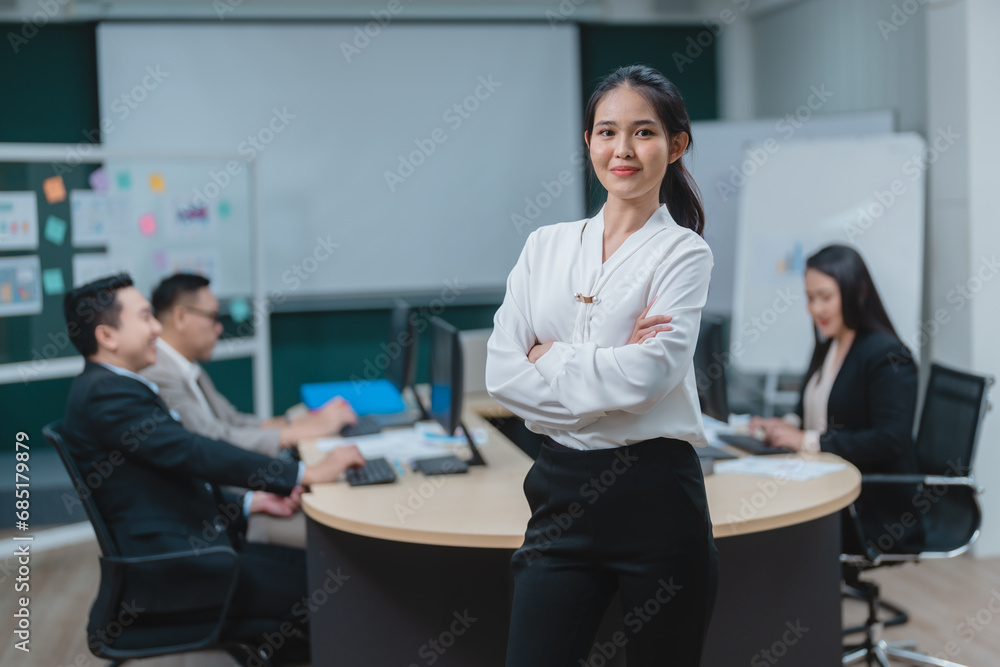 Happy confident smiling young professional Asian business woman corporate leader, Japanese female employee or company sales marketing manager standing arms crossed in office, cute girl portrait Happy confident smiling young professional Asian business woman corporate leader, Japanese female employee or company sales marketing manager standing arms crossed in office, cute girl portrait