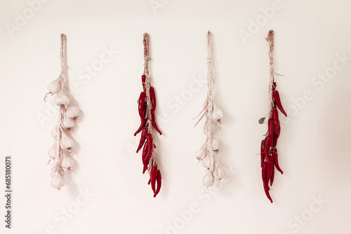 the products of Calabria, chili peppers and garlic hanging on the wall to dry