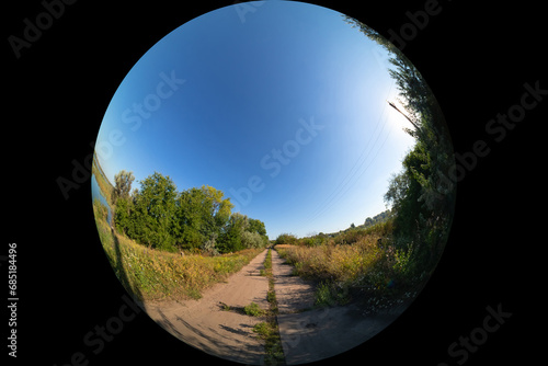 Obraz na płótnie View of an empty country road, shot through a circular fisheye lens with a wide
