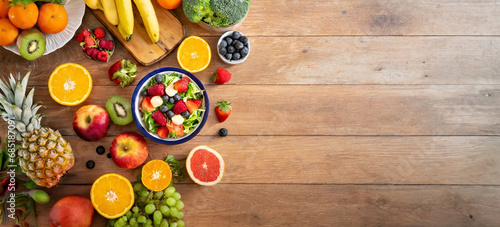 Top view of a tabletop of a wooden table with lots of healthy fruit on it