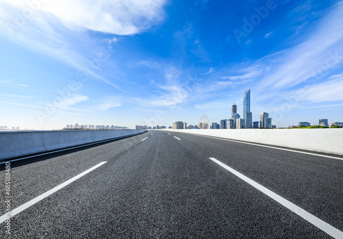 Asphalt highway and city skyline scenery in Suzhou, China.