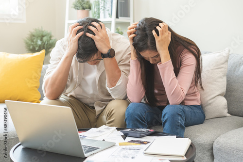 Stressed financial owe asian young couple love sitting suffer, stressed and confused by calculate expense from invoice or bill, no money to pay, mortgage or loan. Debt, bankrupt or bankruptcy people.