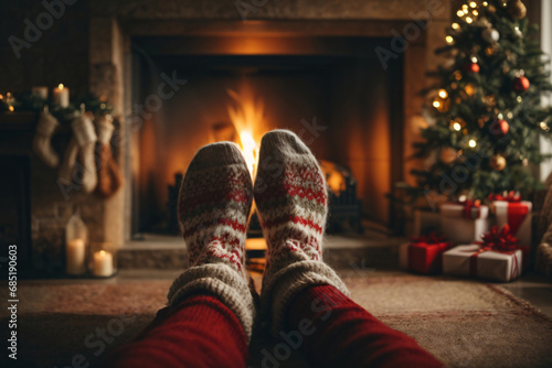 Christmas holiday winter time home greeting card - Feet in wool socks, fireplace in the background.Ai Generative