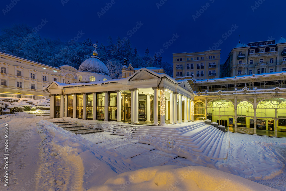 Mariánské Lázně (Marienbad) - white columns pavilion of mineral water spring (Cross Spring - Krizovy pramen) in winter under snow - Czech Republic, Europe