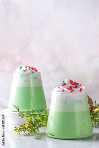 Tableau sur toile Green matcha Christmas latte with whipped cream and sugar sprinkles, on xmas New