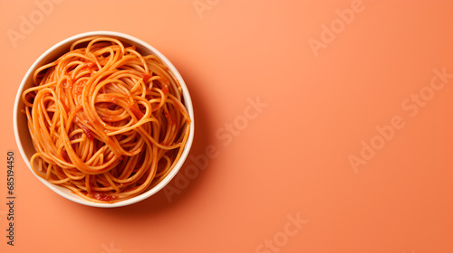 world spaghetti day, bowl of spaghetti on yellow minimalist background with copyspace photo