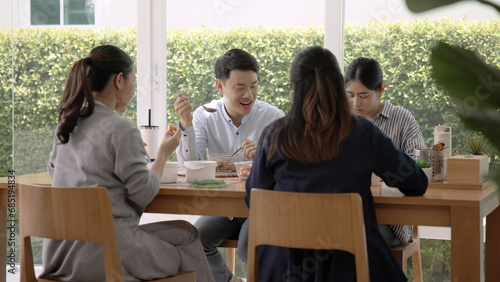 Gen Z asia people group save the planet earth relax eating food go green meal eco friendly glass lunch box reduce plastic waste free water bottle at table SDGs office. ESG net zero happy staff team.