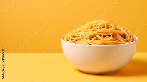 world spaghetti day, bowl of spaghetti on yellow minimalist background with copyspace