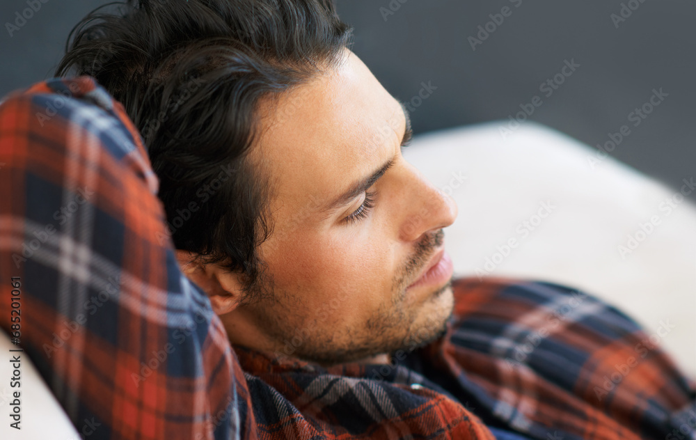 Fototapeta premium Idea, mistake or regret with a man on a sofa in the living room of this home for problem solving. Thinking, stress or depression and a young person in his apartment feeling shame, guilt or remorse