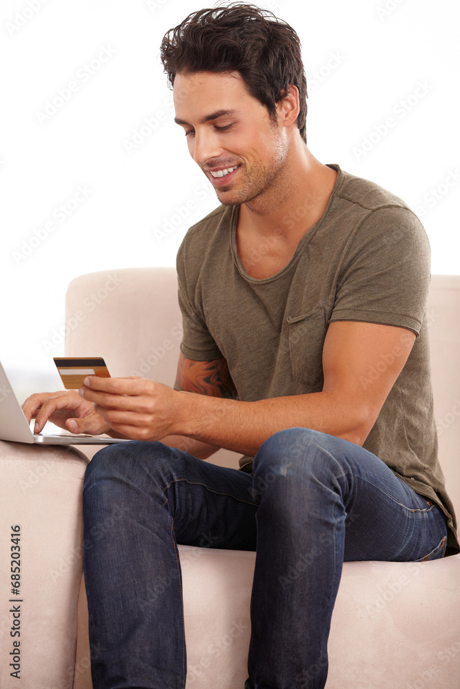 Credit card, computer and man on sofa for online shopping, e commerce and digital payment and home fintech. Person on couch, typing on laptop and internet banking for financial investment or sale