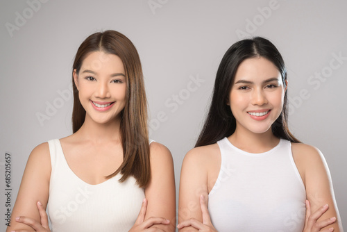 Two beautiful woman in white shirt over white background studio  skin care and beauty concept