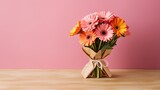 Colourful Daisy Bouquet Wrapped in Brown Paper on a Pink Background. A bouquet of colourful daisies wrapped in brown paper