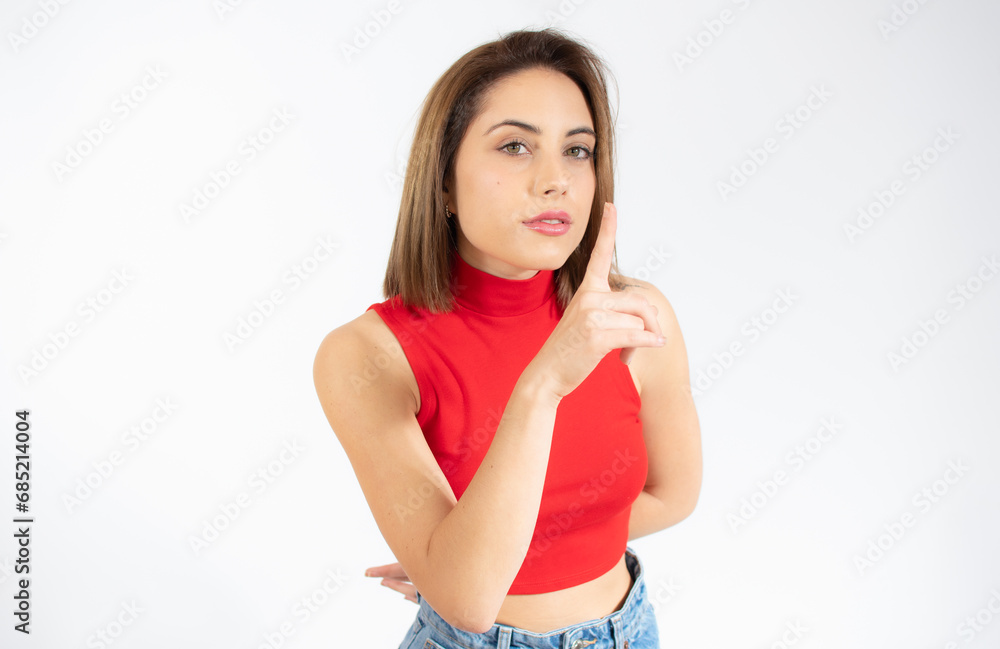 Portrait of beautiful and young woman standing over isolated white background asking to be quiet with finger on lips. Silence and secret concept. Portrait of beautiful and young woman standing over isolated white background asking to be quiet with finger on lips. Silence and secret concept.