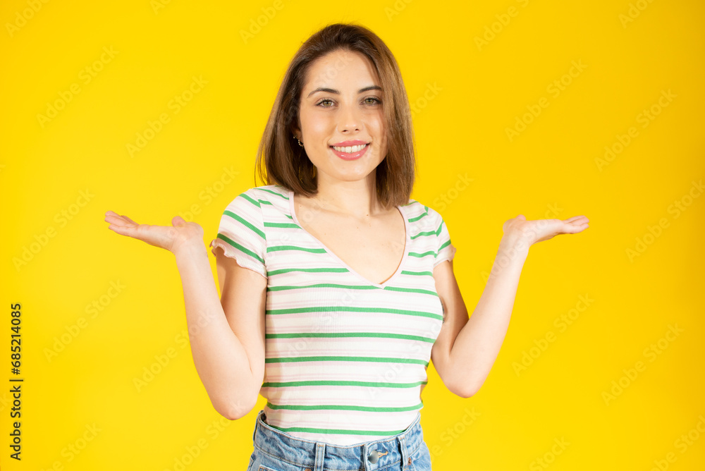 Image of excited young lady standing isolated over yellow background make winner gesture. Image of excited young lady standing isolated over yellow background make winner gesture.