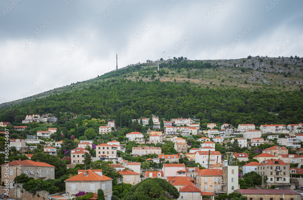 View to the red roofs of Dubrovnik Old town on cloudy summer day. 