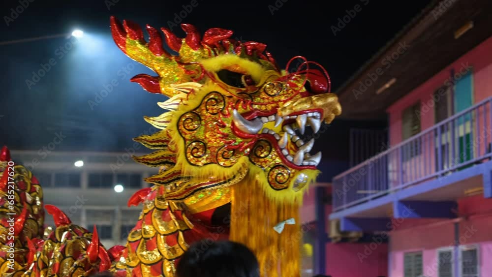 person performing a dragon dance during Chinese New Year celebrations ...