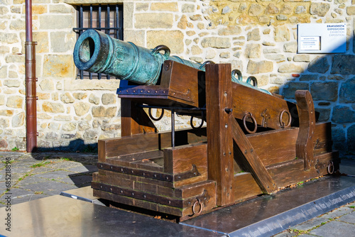 Antique cannon artillery defensive weapon at historic fort building Castillo de la Mota on Mount Urgull, Donostia-San Sebastian, Basque Country, Spain photo