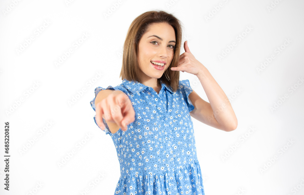 Call me gesture by beautiful young woman isolated over white background. Call me gesture by beautiful young woman isolated over white background.