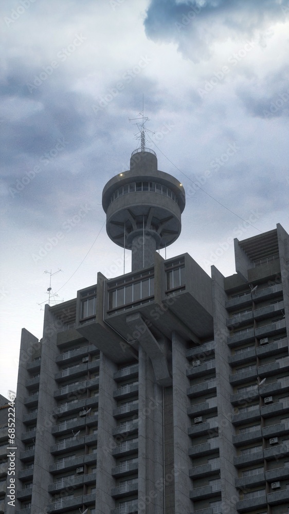 Brutalist architecture. A tall concrete residential estate with a tower on top of it's side and a grey cloudy sky in the background. Photorealistic 3D illustration. Brutalist architecture. A tall concrete residential estate with a tower on top of it's side and a grey cloudy sky in the background. Photorealistic 3D illustration.