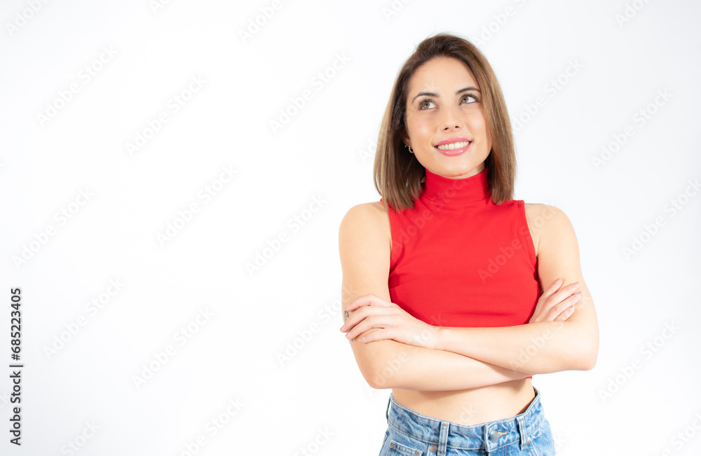 Portrait of a smiling young woman standing with arms folded isolated over white background Portrait of a smiling young woman standing with arms folded isolated over white background