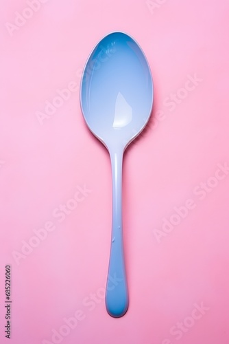Blue-handled Spoon Resting on a Vibrant Pink Surface for Kitchen and Dining Concepts and Ideas Generative AI