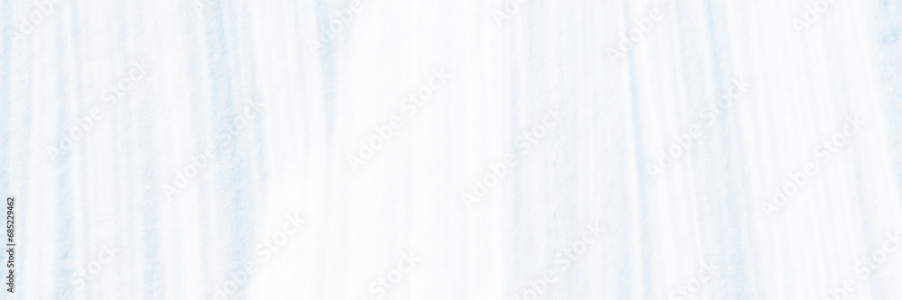 Wide panoramic winter background with snowy ground. Natural snow texture. Wind sculpted patterns on snow surface. Wide panoramic winter background with snowy ground. Natural snow texture. Wind sculpted patterns on snow surface.