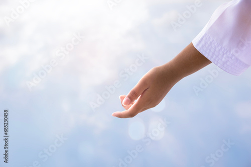 Jesus Christ with open arms reaching out to help in the sky photo