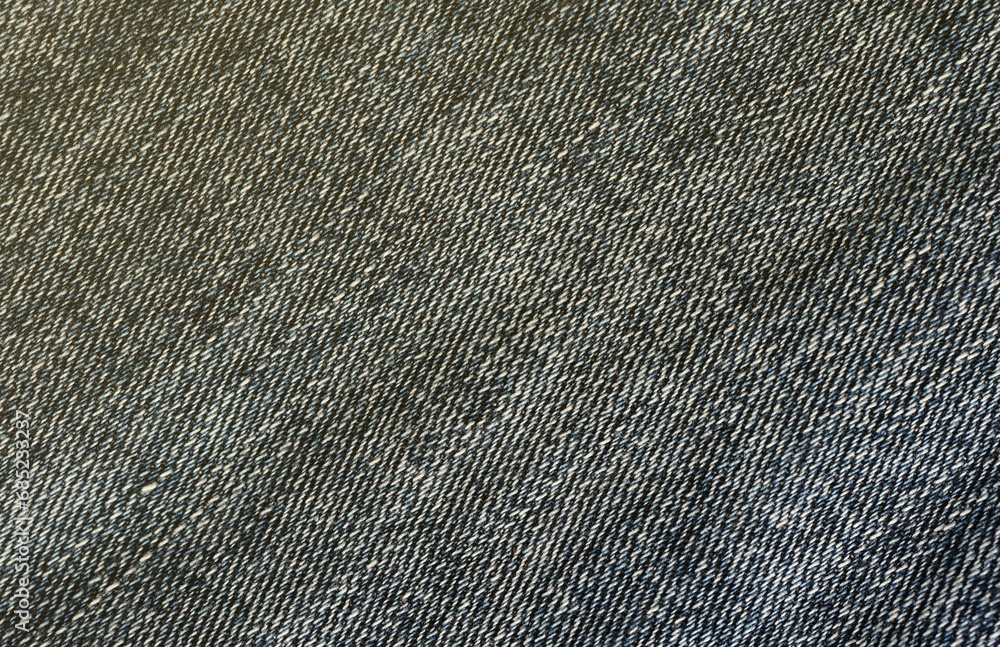Detailed abstract texture of dark blue denim cloth. Background image of old used denim trousers fabric close up Detailed abstract texture of dark blue denim cloth. Background image of old used denim trousers fabric close up