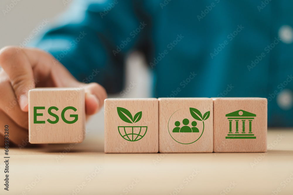 ESG environmental, social and governance. businessman holding wood ...