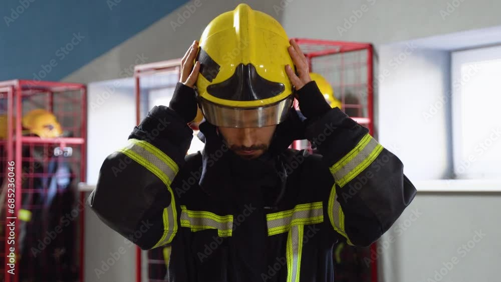 Fireman removes the protective helmet in fire department Fireman removes the protective helmet in fire department