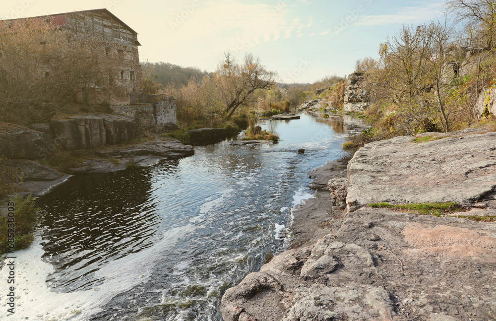 Rocky bank, mountain landscape. View of mountain river in early spring. Nature landscape, wilderness. Bukski canyon and Tikich river Rocky bank, mountain landscape. View of mountain river in early spring. Nature landscape, wilderness. Bukski canyon and Tikich river