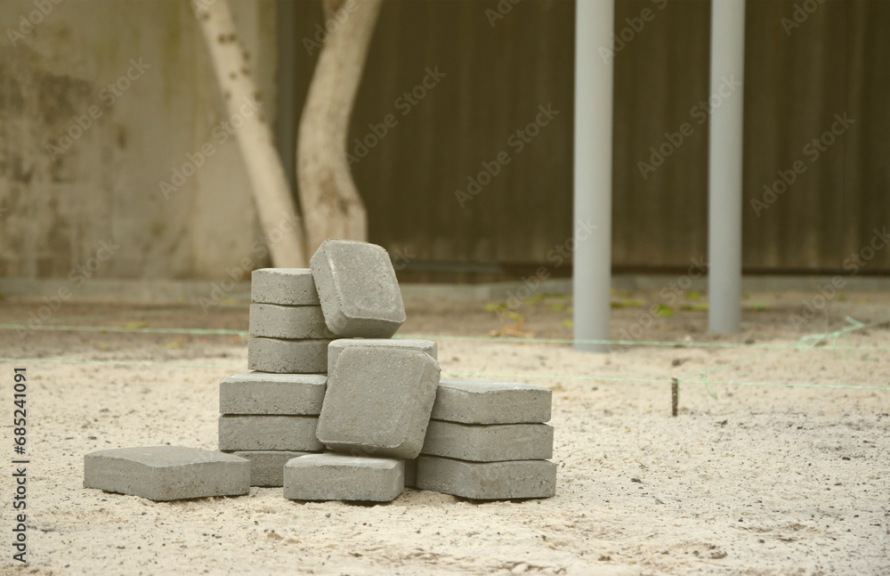 Small pile of gray walkway slabs lying in stack outdoors. Material for Paving Slabs by mosaic in progress. Cobblestone installation process Small pile of gray walkway slabs lying in stack outdoors. Material for Paving Slabs by mosaic in progress. Cobblestone installation process