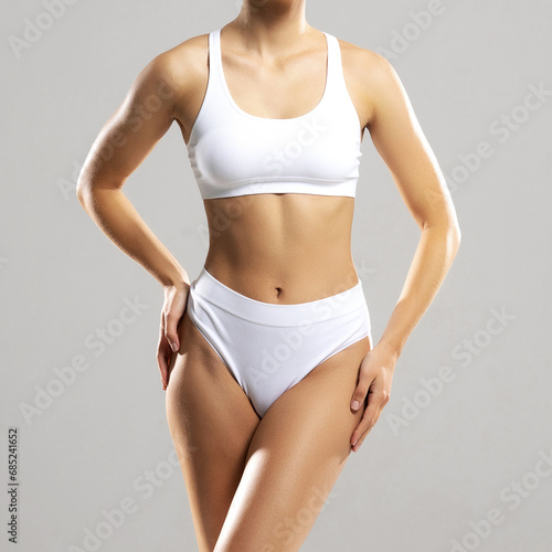 Perfect body of young and beautiful woman in swimsuit isolated on white. Weight loss, diet, sport and fitness concepts.