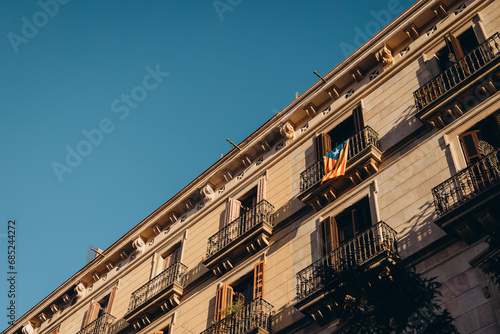 flag of Catalonia on the balcony of an old house in Europe, old quarter in Barcelona, symbol of Catalonia