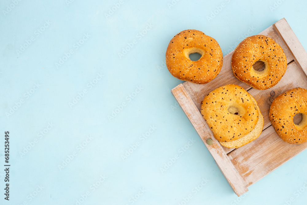 Set of fresh bread bagels on wooden board, top view Set of fresh bread bagels on wooden board, top view