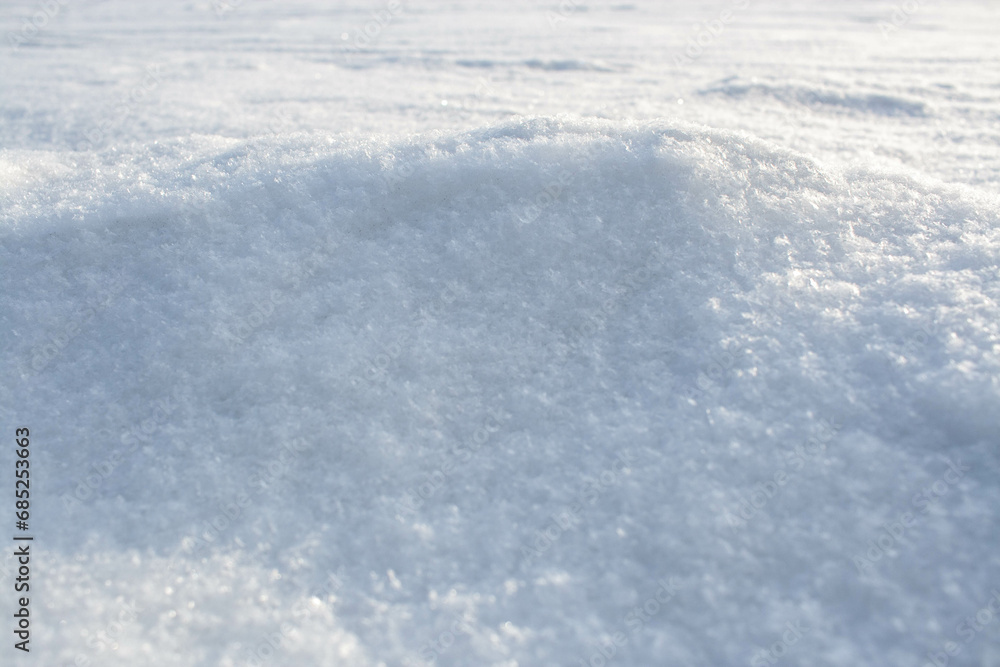 Obraz premium Natural snow texture of snowdrift. Winter backdrop with snowy ground. Patterns on snow surface.