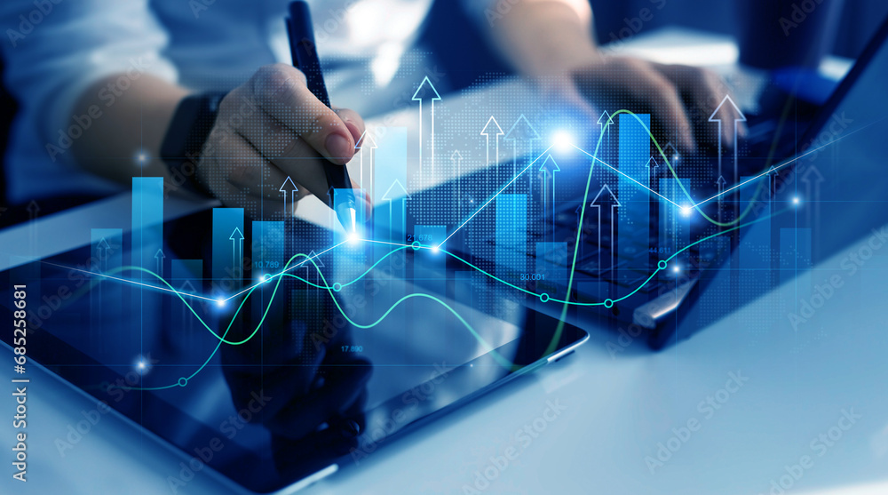 Fototapeta premium Business person drawing on tablet growing virtual hologram of statistics, graph and chart.Business strategy development and growing growth plan. 