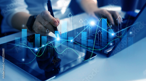 Business person drawing on tablet growing virtual hologram of statistics, graph and chart.Business strategy development and growing growth plan.  photo