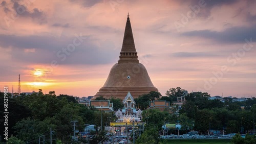 Majestic golden pagoda of Phra Pathom Chedi with colorful sunset sky in downtown at Nakhon Pathom photo